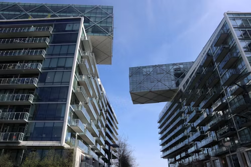 feng shui architecture with modern glass and metal buildings and a skybridge showing flow and materials