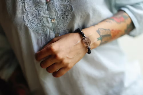feng shui bracelet with black beads and a crystal worn on the wrist
