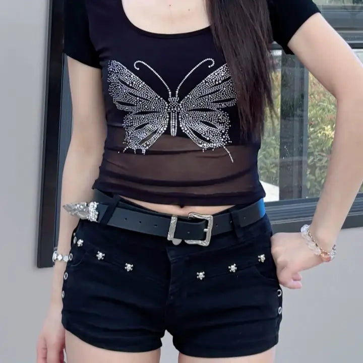Model wearing black casual belt for women with jeans and black top, showing the engraved silver buckle and western tip.