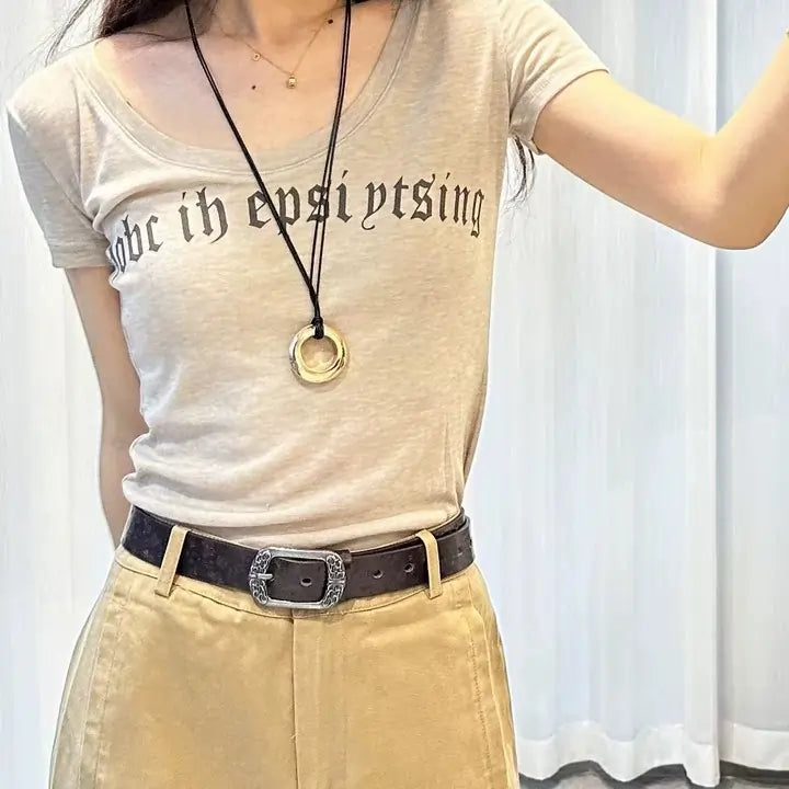 Woman wearing embossed black casual belt with butterfly pattern and vintage buckle