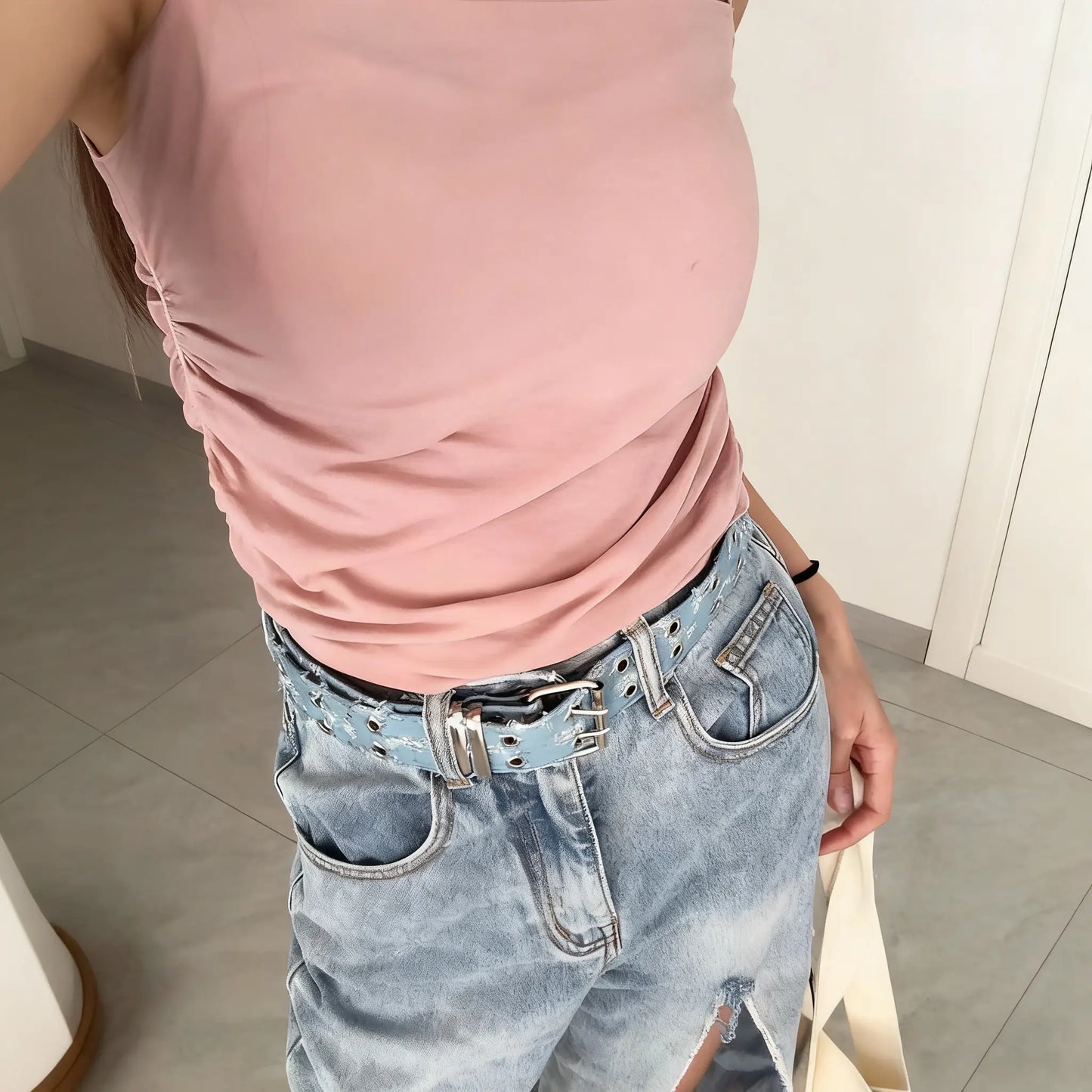 Women’s Y2K denim studded belt styled with jeans – trendy casual look