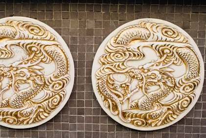 dragon china display with two gold relief porcelain dragon plaques on a tiled wall, illustrating safe spacing and lighting