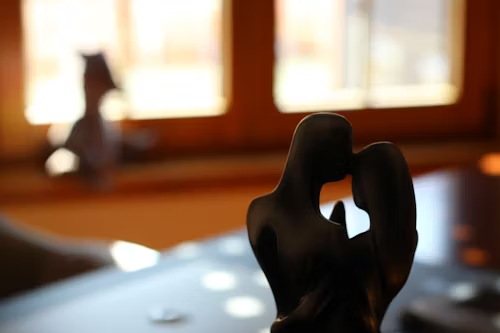figurines meaning shown by an abstract couple figurine on a table, symbolizing lucky pairs and harmony