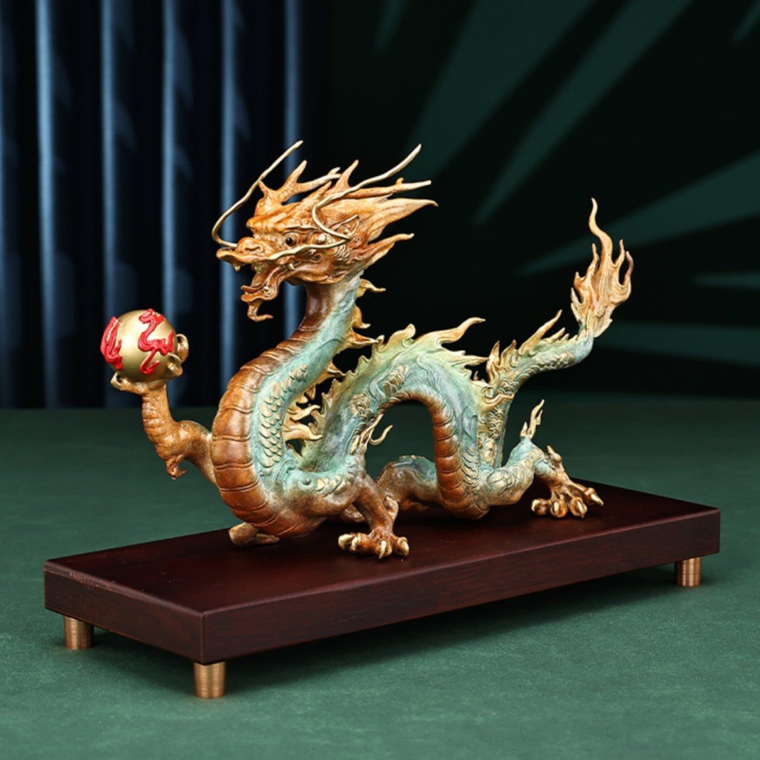 Angled view of Prosperity Dragon bronze statue holding golden pearl for good fortune